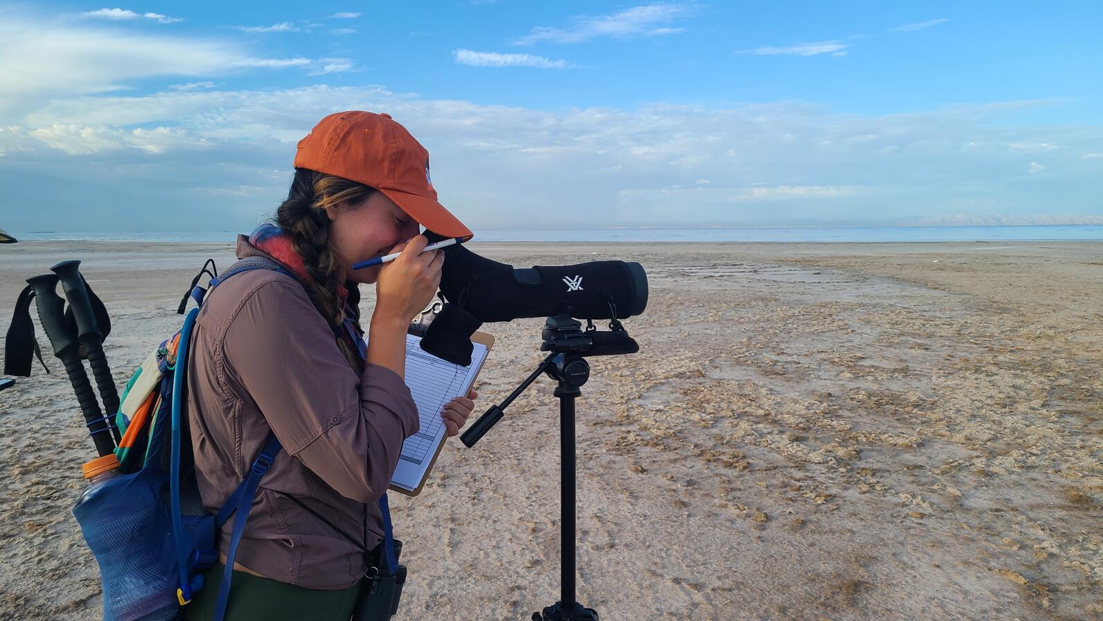 Liliana Griego, Senior Program Manager of Coasts, observing shorebirds at the Salton Sea during the historic Intermountain West Shorebird Survey in August 2023. 